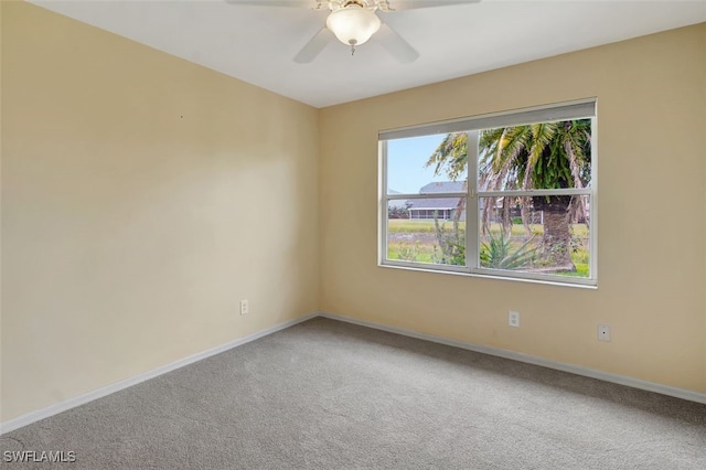 empty room with ceiling fan and carpet