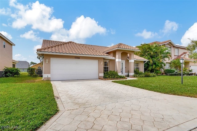 mediterranean / spanish-style house featuring a front yard and a garage