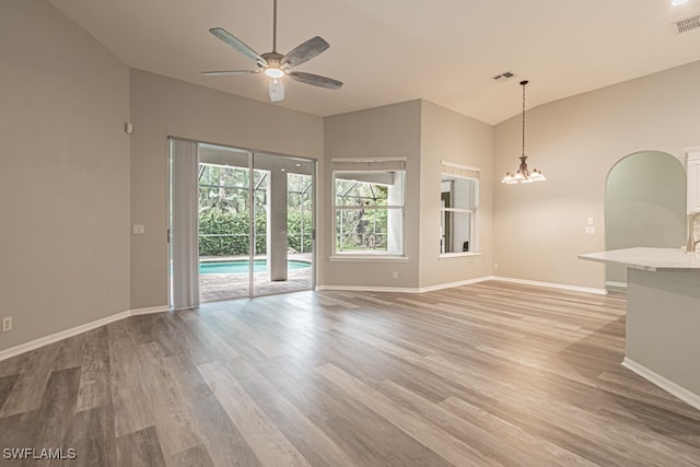 empty room featuring lofted ceiling, ceiling fan, and light hardwood / wood-style floors