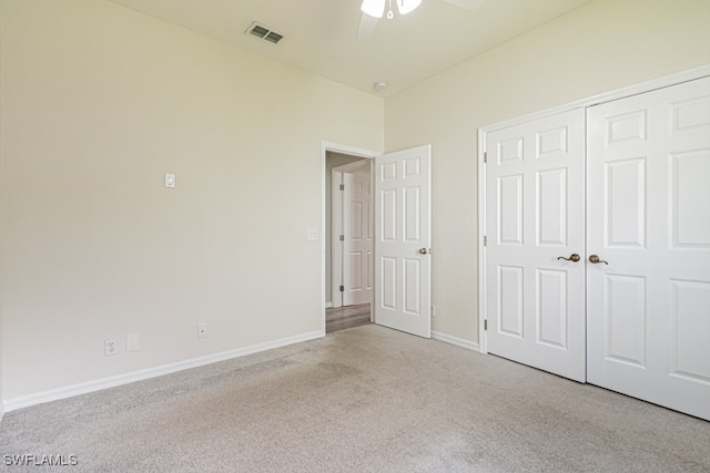 unfurnished bedroom with a closet, ceiling fan, and light colored carpet