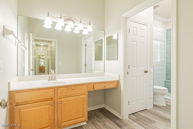 bathroom featuring crown molding, vanity, toilet, and wood-type flooring