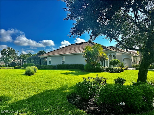 view of side of home with a garage and a yard