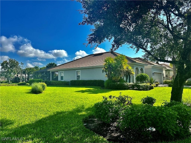 view of property exterior featuring a garage, stucco siding, a tiled roof, and a yard