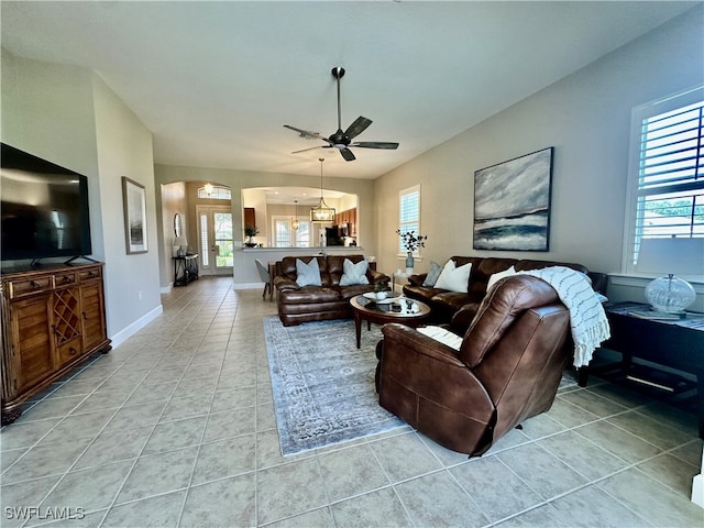 living room with light tile patterned flooring and ceiling fan