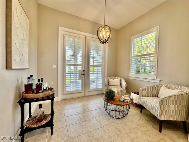 living area with an inviting chandelier, french doors, and light tile patterned floors