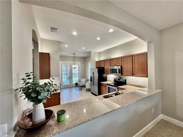 kitchen with stainless steel appliances, kitchen peninsula, light stone countertops, light tile patterned floors, and pendant lighting