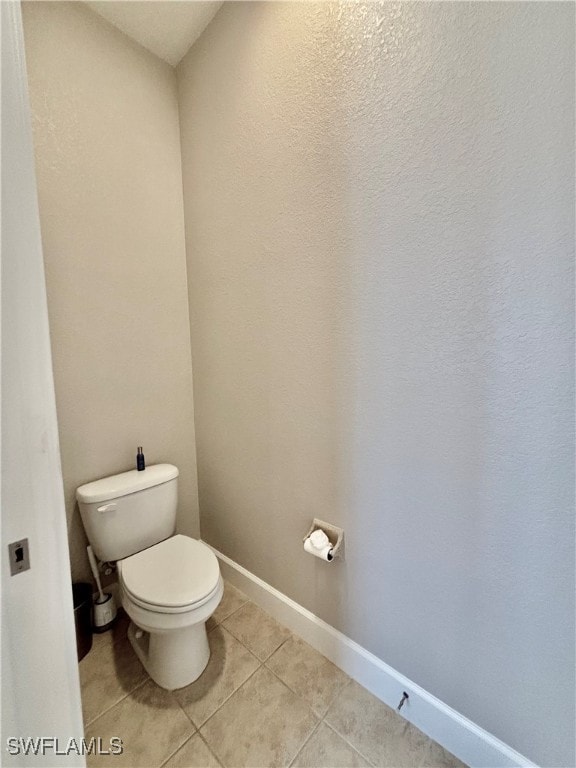 bathroom featuring tile patterned flooring and toilet