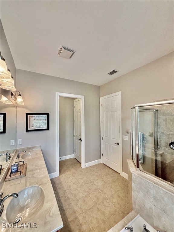 bathroom featuring vanity, tile patterned floors, and a shower with shower door