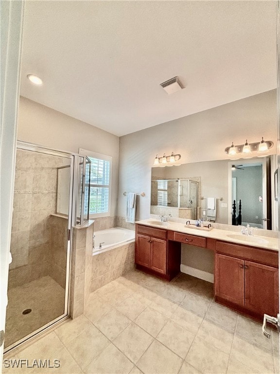 bathroom with shower with separate bathtub, vanity, and tile patterned floors