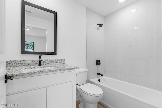 2739 NE 5th Ave, Cape Coral, FL 33909 - bathroom featuring toilet, vanity, shower / bathtub combination, and wood finished floors