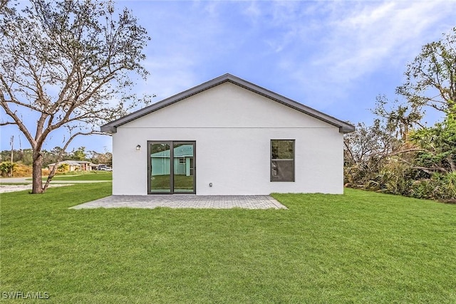 2739 NE 5th Ave, Cape Coral, FL 33909 - rear view of property with a yard, a patio, and stucco siding