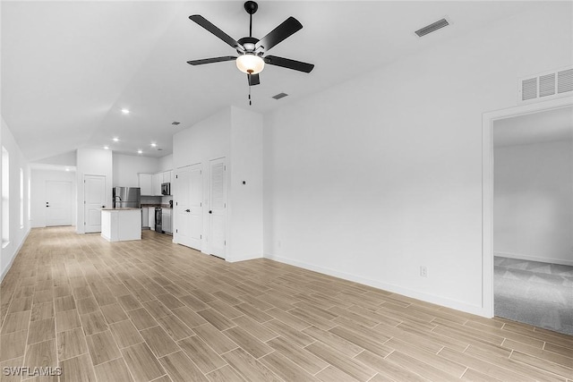 25 NW 1st Way, Cape Coral, FL 33993 - unfurnished living room featuring lofted ceiling, baseboards, ceiling fan, recessed lighting, and light wood-style flooring