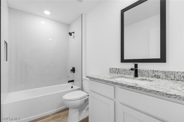 25 NW 1st Way, Cape Coral, FL 33993 - bathroom featuring wood finished floors, toilet, vanity, washtub / shower combination, and recessed lighting