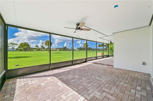 unfurnished sunroom featuring ceiling fan