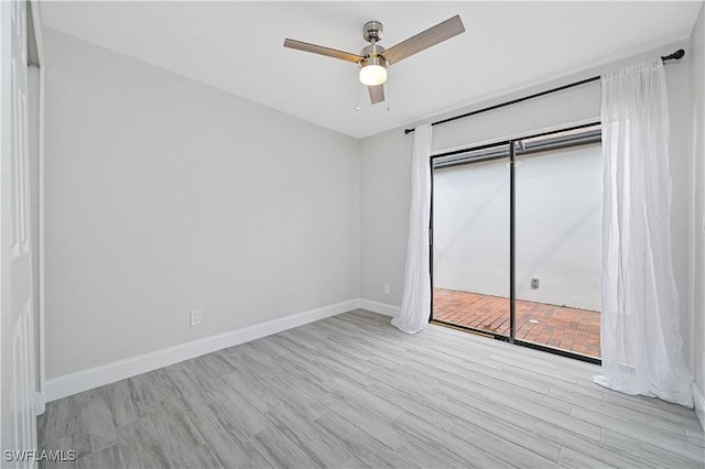 unfurnished bedroom featuring a closet, baseboards, wood finished floors, and a ceiling fan