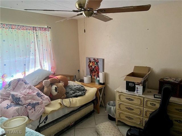 tiled bedroom featuring ceiling fan