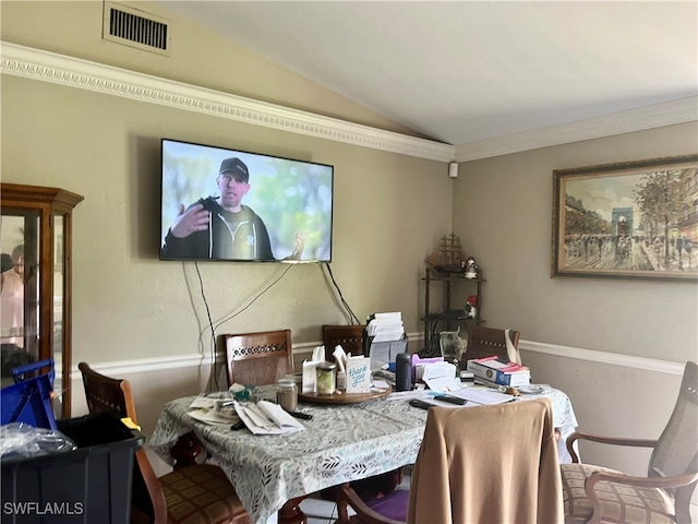 dining area with lofted ceiling and ornamental molding