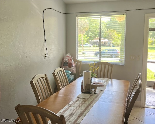 dining space with light tile patterned floors and plenty of natural light