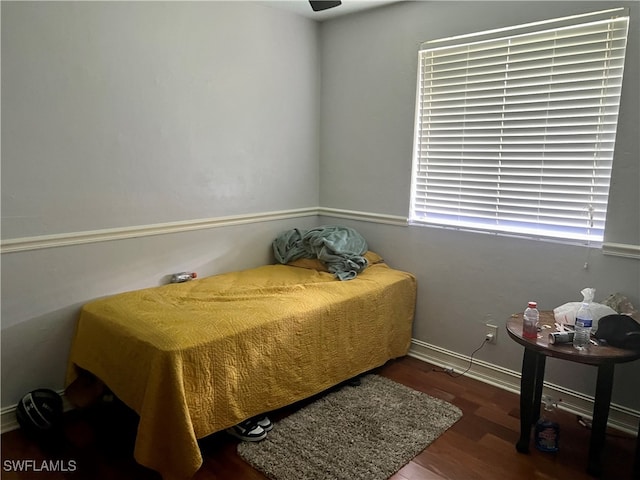 bedroom with dark wood-type flooring