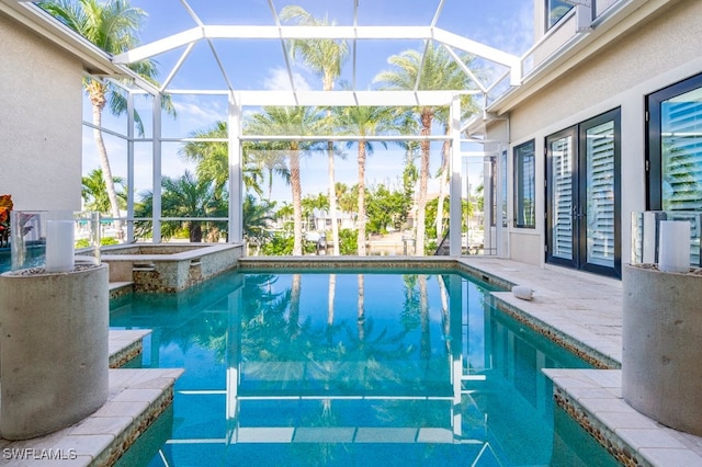 view of pool featuring glass enclosure