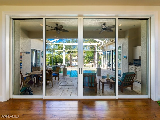 doorway to outside featuring ceiling fan and wood-type flooring