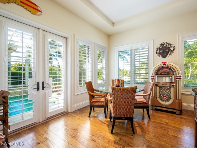 dining space with french doors and wood-type flooring