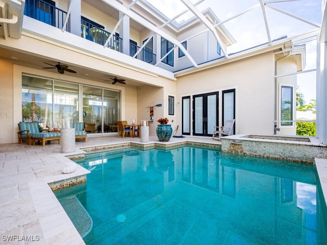 view of pool with ceiling fan, a patio, and french doors