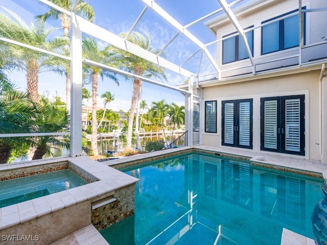 view of swimming pool with an in ground hot tub and a lanai