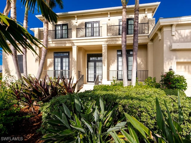 property entrance featuring a balcony and covered porch