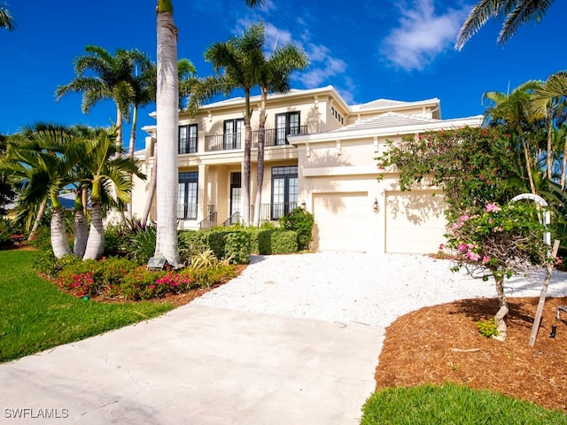 view of front of property featuring a balcony and a garage