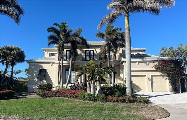 view of front of home featuring a balcony and a garage