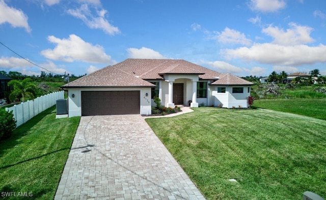 view of front of property featuring a garage and a front yard