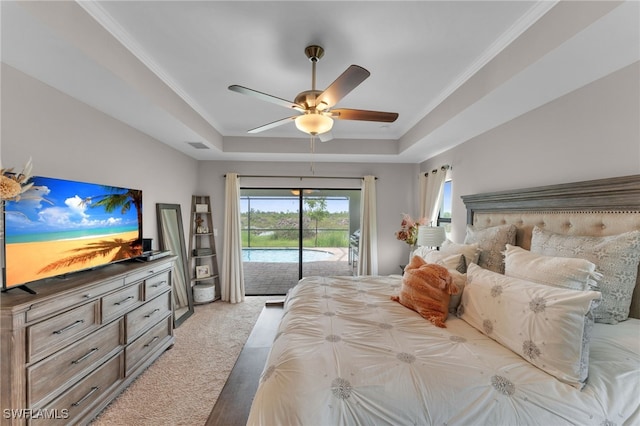 bedroom with ceiling fan, a raised ceiling, access to exterior, and light carpet