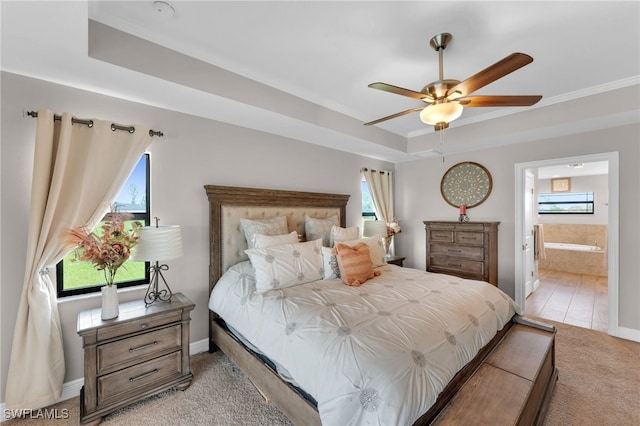 carpeted bedroom featuring ceiling fan, ornamental molding, ensuite bathroom, and multiple windows