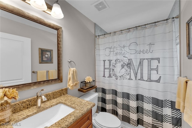 bathroom with vanity, toilet, and curtained shower