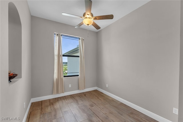 spare room with light wood-type flooring and ceiling fan