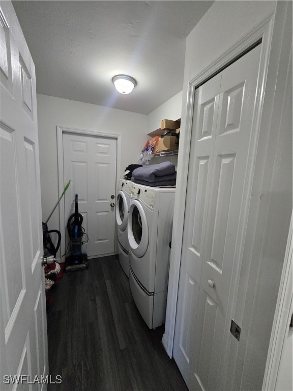 laundry area featuring dark hardwood / wood-style floors and washer and clothes dryer