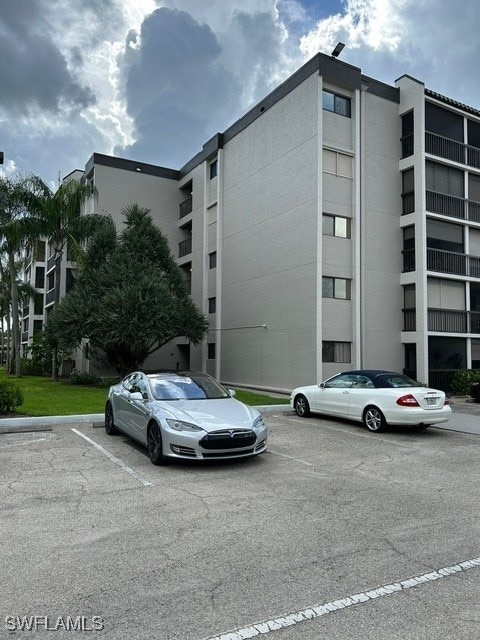 view of property featuring uncovered parking