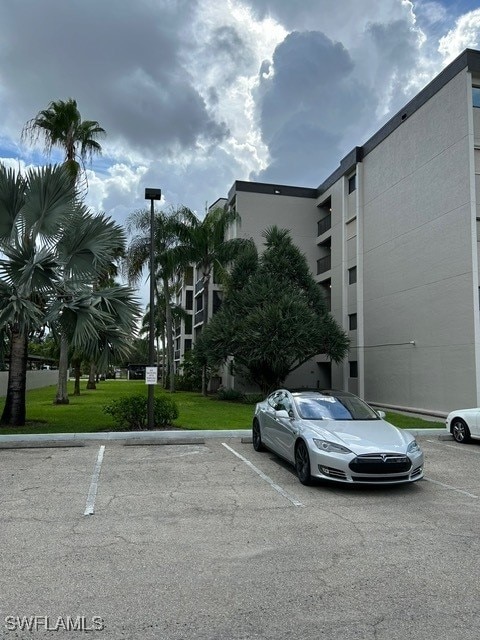 view of building exterior with uncovered parking