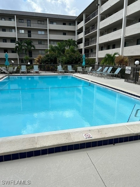view of swimming pool with fence