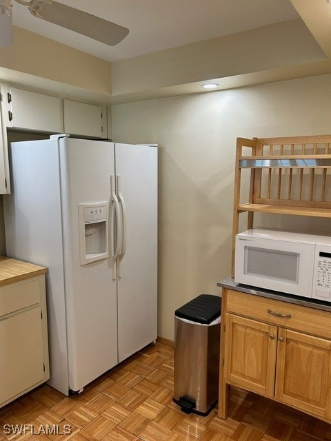 kitchen with ceiling fan, white appliances, and light parquet flooring