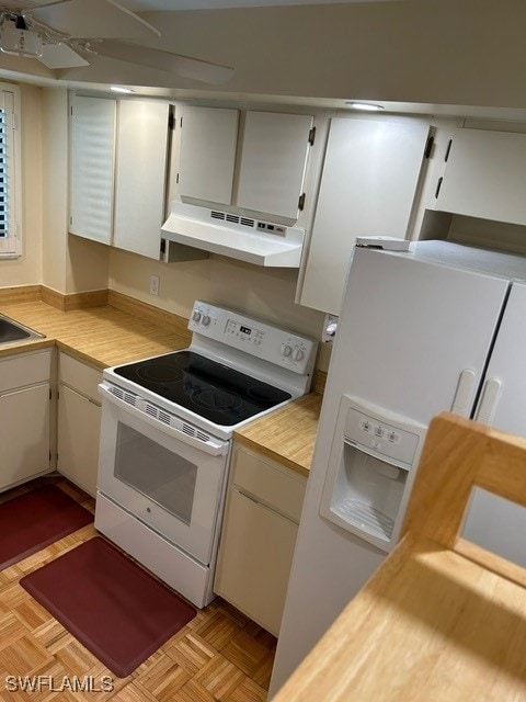 kitchen featuring white cabinetry, white appliances, under cabinet range hood, a sink, and ceiling fan