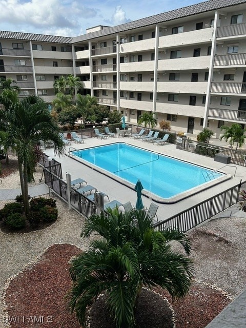 pool with fence and a patio area