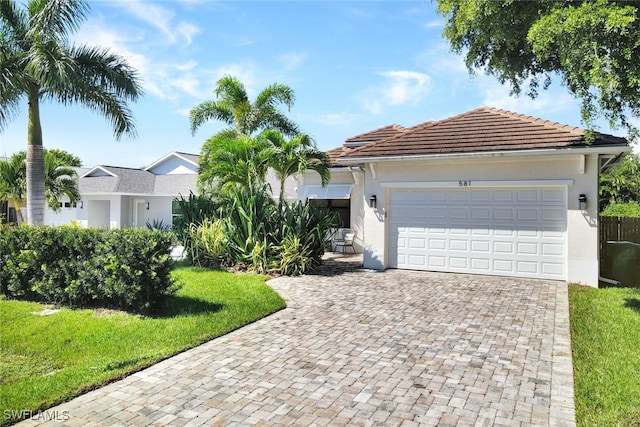 view of front of house with a front lawn and a garage