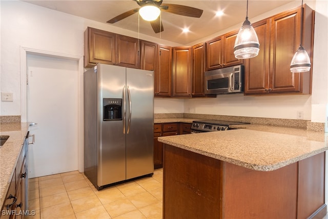 kitchen featuring pendant lighting, kitchen peninsula, light stone countertops, ceiling fan, and appliances with stainless steel finishes