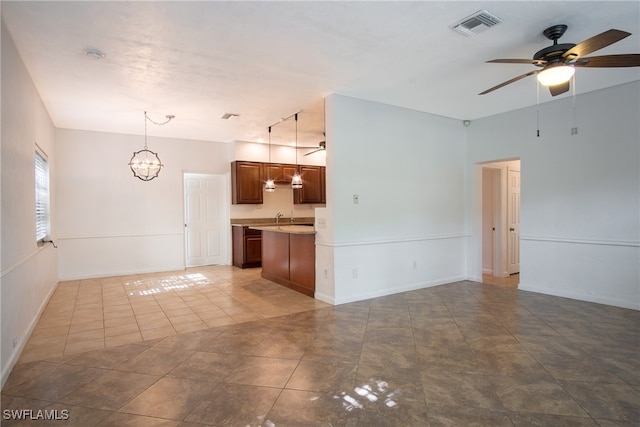 kitchen featuring ceiling fan with notable chandelier, decorative light fixtures, sink, and light tile patterned flooring