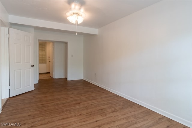 unfurnished room with hardwood / wood-style floors