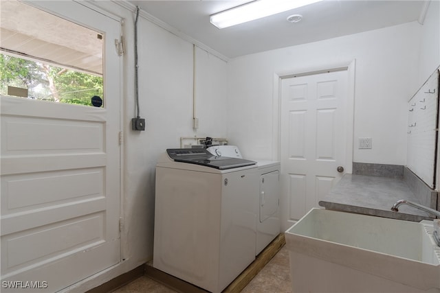 washroom featuring washing machine and clothes dryer and sink