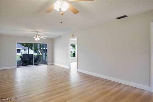 spare room with a textured ceiling, light hardwood / wood-style flooring, and ceiling fan