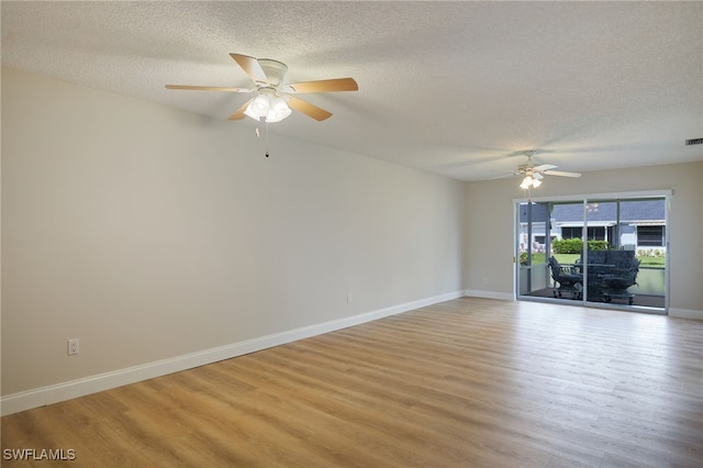 empty room with light wood-type flooring, a textured ceiling, and ceiling fan